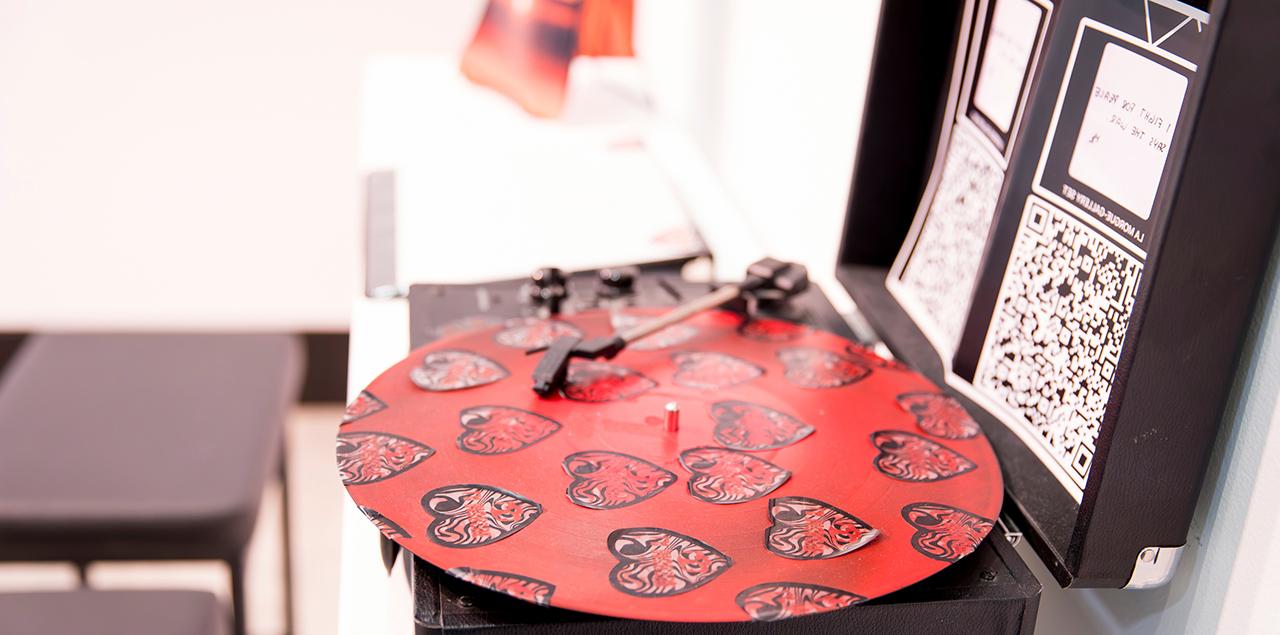 Record player 与 the needle down on a record covered in hearts